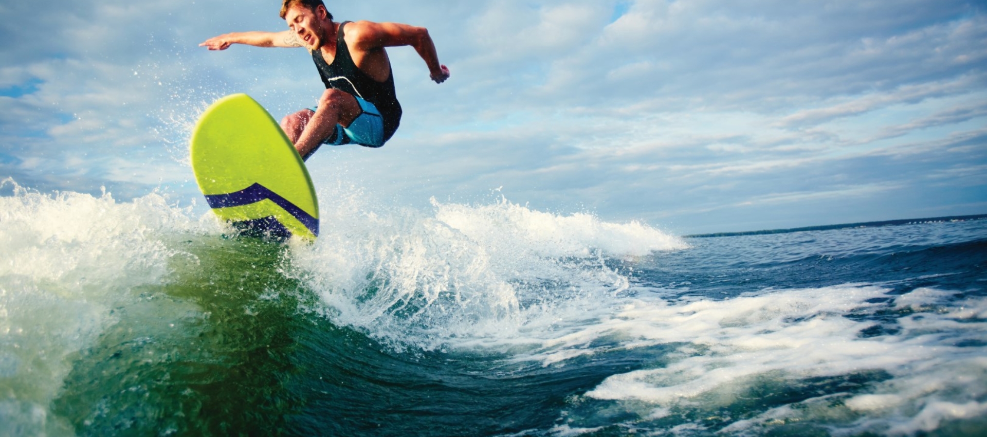 Male surfer riding on waves in the sea